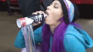 Sasha Banks taking a massive shot of a white substance in her mouth and swallowing